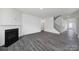 Cozy living room featuring wood-style floors, fireplace, and a staircase leading to the upper level at 300 Kennerly Center Dr, Mooresville, NC 28115