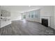 Spacious living area with wood-style floors, a fireplace, and sliding glass doors to the backyard at 300 Kennerly Center Dr, Mooresville, NC 28115