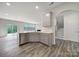 Bright open-concept living space featuring a modern kitchen, wood-style floors and open staircase at 300 Kennerly Center Dr, Mooresville, NC 28115