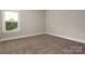 Comfortable bedroom with neutral carpet, a window for natural light, and soft trim at 3009 Ocaso Ct, Matthews, NC 28104