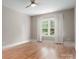 Bedroom with wood floors, neutral paint, and a window with sheer curtains at 3009 Ocaso Ct, Matthews, NC 28104