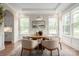 Bright dining room with modern lighting, a round table, and views to the manicured backyard at 3009 Ocaso Ct, Matthews, NC 28104
