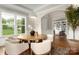 Dining room with modern lighting, a round table, and view to the backyard and office area at 3009 Ocaso Ct, Matthews, NC 28104