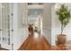 Elegant foyer with hardwood floors, detailed trim, and a view into the light-filled living spaces at 3009 Ocaso Ct, Matthews, NC 28104