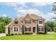 Attractive brick home featuring manicured landscaping, two stories, and a welcoming front entrance at 3009 Ocaso Ct, Matthews, NC 28104