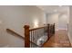 Hallway features hardwood floors, black iron and wood railing, and neutral paint color at 3009 Ocaso Ct, Matthews, NC 28104