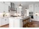 Bright, modern kitchen features white cabinetry, stainless steel appliances, and a large island with seating at 3009 Ocaso Ct, Matthews, NC 28104