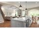 Open-concept living area with hardwood floors, fireplace, and seamless flow into kitchen and dining at 3009 Ocaso Ct, Matthews, NC 28104