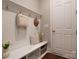 Cozy mudroom with white bench, coat hooks, and open storage for organization at 3009 Ocaso Ct, Matthews, NC 28104