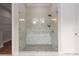 Modern glass shower featuring dual shower heads, mosaic flooring, and a built in bench at 3009 Ocaso Ct, Matthews, NC 28104