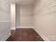 Walk-in closet with wooden floors and white shelving units for ample storage at 3009 Ocaso Ct, Matthews, NC 28104