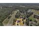 Stunning aerial view of the property, showcasing its landscaped yard, golf course views, and proximity to the lake at 3068 River Rd, Shelby, NC 28152
