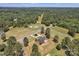 Aerial view of an elegant home, beautifully landscaped yard, and surrounding golf course in a serene, wooded setting at 3068 River Rd, Shelby, NC 28152