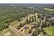 Breathtaking aerial view showcasing a stunning property on a golf course with lush greenery and mature trees at 3068 River Rd, Shelby, NC 28152