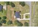 Birds-eye view of a beautiful home with a long driveway and well-manicured grounds, surrounded by lush trees and landscaping at 3068 River Rd, Shelby, NC 28152