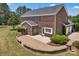 Expansive brick home featuring a large patio, manicured landscaping, and a well-maintained lawn, perfect for outdoor enjoyment at 3068 River Rd, Shelby, NC 28152