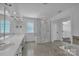 Expansive bathroom with double vanities, glass enclosed shower, and a soaking tub, illuminated by recessed lighting at 3068 River Rd, Shelby, NC 28152