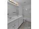 Bright bathroom featuring a double sink vanity, ceramic tile floors, and bathtub with shower at 3068 River Rd, Shelby, NC 28152