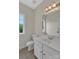 Bright bathroom featuring a white vanity, neutral tile flooring, and a natural light window at 3068 River Rd, Shelby, NC 28152
