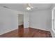 Minimalist bedroom with hardwood floors, simple ceiling fan, and neutral walls, providing a versatile space at 3068 River Rd, Shelby, NC 28152