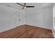 Well-lit bedroom with hardwood floors, ceiling fan, and closet with double doors at 3068 River Rd, Shelby, NC 28152