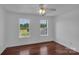 Cozy bedroom with hardwood floors, two windows providing ample light, and simple, clean lines at 3068 River Rd, Shelby, NC 28152