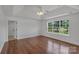 Spacious bedroom featuring hardwood floors, a tray ceiling, and a large window with natural light at 3068 River Rd, Shelby, NC 28152
