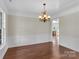 Elegant dining room with hardwood floors, wainscoting, and a decorative chandelier at 3068 River Rd, Shelby, NC 28152