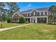Attractive two-story brick home with a well-maintained lawn and manicured landscaping, offering great curb appeal at 3068 River Rd, Shelby, NC 28152
