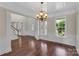Elegant foyer with gleaming hardwood floors, detailed molding, and a grand chandelier, creating a welcoming entrance at 3068 River Rd, Shelby, NC 28152