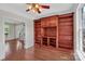 Elegant living room with a large built-in bookcase and hardwood floors at 3068 River Rd, Shelby, NC 28152