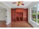 Bright living room featuring hardwood floors, a built-in bookcase and a large window at 3068 River Rd, Shelby, NC 28152