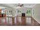 Open living room with fireplace, hardwood floors and multiple windows with backyard views at 3068 River Rd, Shelby, NC 28152