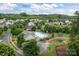 Community view showcasing a pool, playground and residential area amidst green trees at 308 Planters Way, Mount Holly, NC 28120