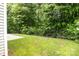 Spacious backyard with a well-maintained lawn, concrete patio, and a classic black fence, perfect for outdoor gatherings at 308 Planters Way, Mount Holly, NC 28120
