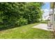 Cozy backyard featuring a well-maintained lawn, concrete patio, and a classic black fence, perfect for outdoor enjoyment at 308 Planters Way, Mount Holly, NC 28120