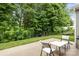 Private backyard featuring a patio with a table and chairs, perfect for outdoor entertaining and relaxation at 308 Planters Way, Mount Holly, NC 28120