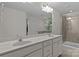 Bathroom with double sinks, a large mirror, and a glass-enclosed shower at 308 Planters Way, Mount Holly, NC 28120