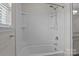 Bathroom with a shower and tub combination, complemented by shelving and chrome fixtures at 308 Planters Way, Mount Holly, NC 28120