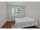 Bright bedroom with hardwood floors features a large window for natural light at 308 Planters Way, Mount Holly, NC 28120