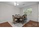 Elegant dining room with hardwood floors, a classic chandelier, and ample seating for Gathering and guests at 308 Planters Way, Mount Holly, NC 28120