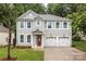Charming two-story home with a well-manicured lawn, two-car garage, and inviting curb appeal at 308 Planters Way, Mount Holly, NC 28120