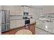Modern kitchen with stainless steel appliances, subway tile backsplash, and granite countertops at 308 Planters Way, Mount Holly, NC 28120