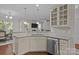Modern kitchen featuring stainless steel appliances, granite counters, and a convenient breakfast bar area at 308 Planters Way, Mount Holly, NC 28120