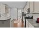 Bright kitchen featuring granite countertops, stainless steel appliances, and hardwood floors at 308 Planters Way, Mount Holly, NC 28120
