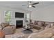 Inviting living room with a cozy fireplace, comfortable seating, and ample natural light at 308 Planters Way, Mount Holly, NC 28120