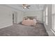 Spacious bedroom with a ceiling fan, walk-in closet and natural light from the windows at 308 Planters Way, Mount Holly, NC 28120