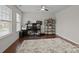 Bright office space with hardwood floors, modern desk, and shelving unit, perfect for a productive work environment at 308 Planters Way, Mount Holly, NC 28120