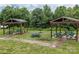 Community picnic area featuring covered picnic tables, perfect for neighborhood gatherings and outdoor dining experiences at 308 Planters Way, Mount Holly, NC 28120