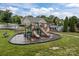 Community playground with slides and play structures adjacent to the pool area, perfect for Gathering fun and recreation at 308 Planters Way, Mount Holly, NC 28120